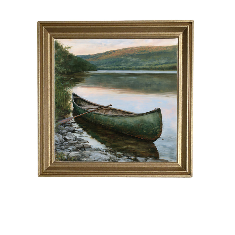 Weathered green wooden canoe pulled partly onto a lakeshore, rustic countryside scene — product view 5