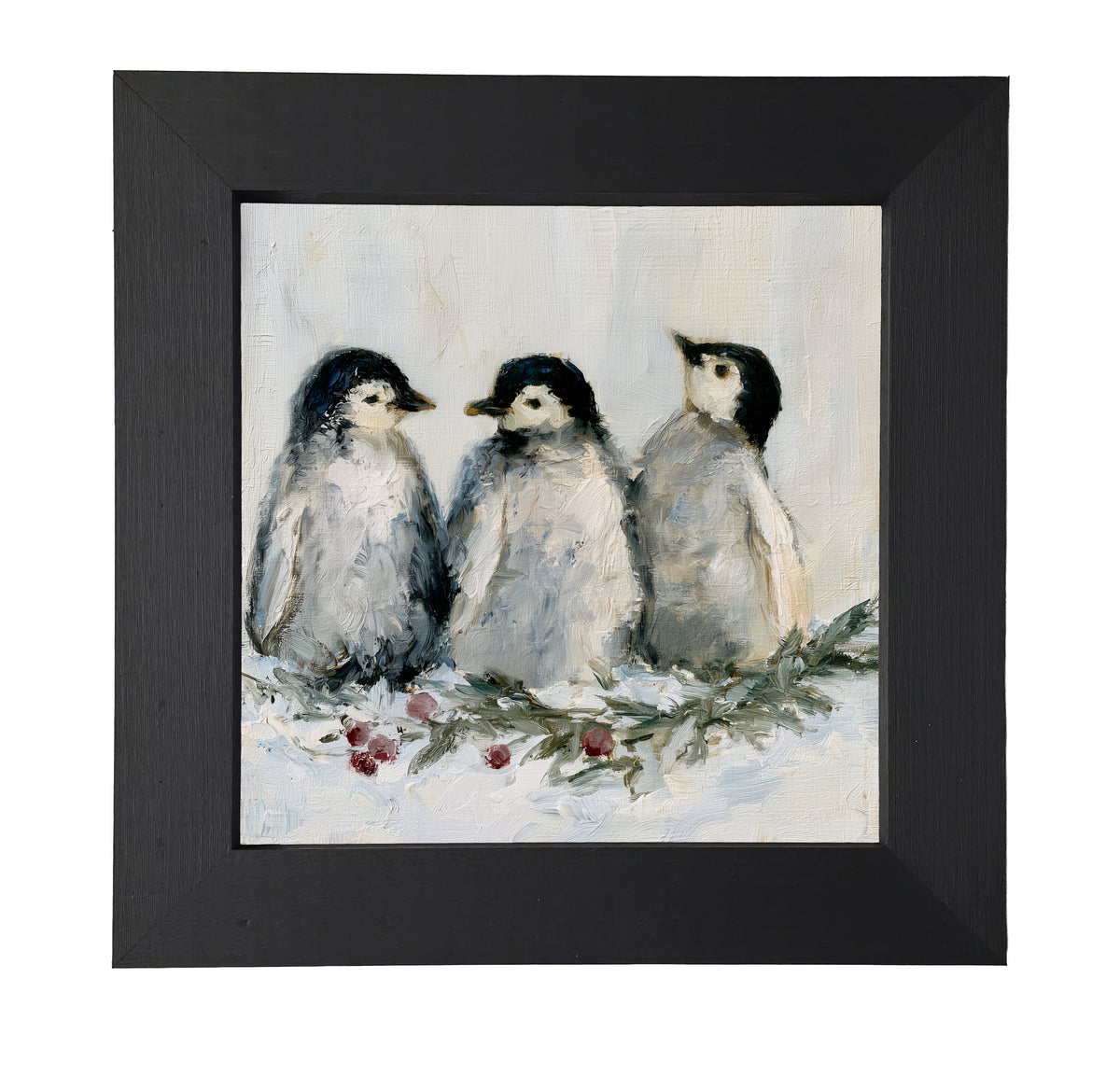 three small penguins standing close together in a rustic winter scene