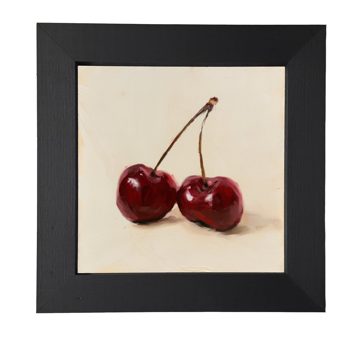 still life of two deep red cherries resting together, farmhouse style