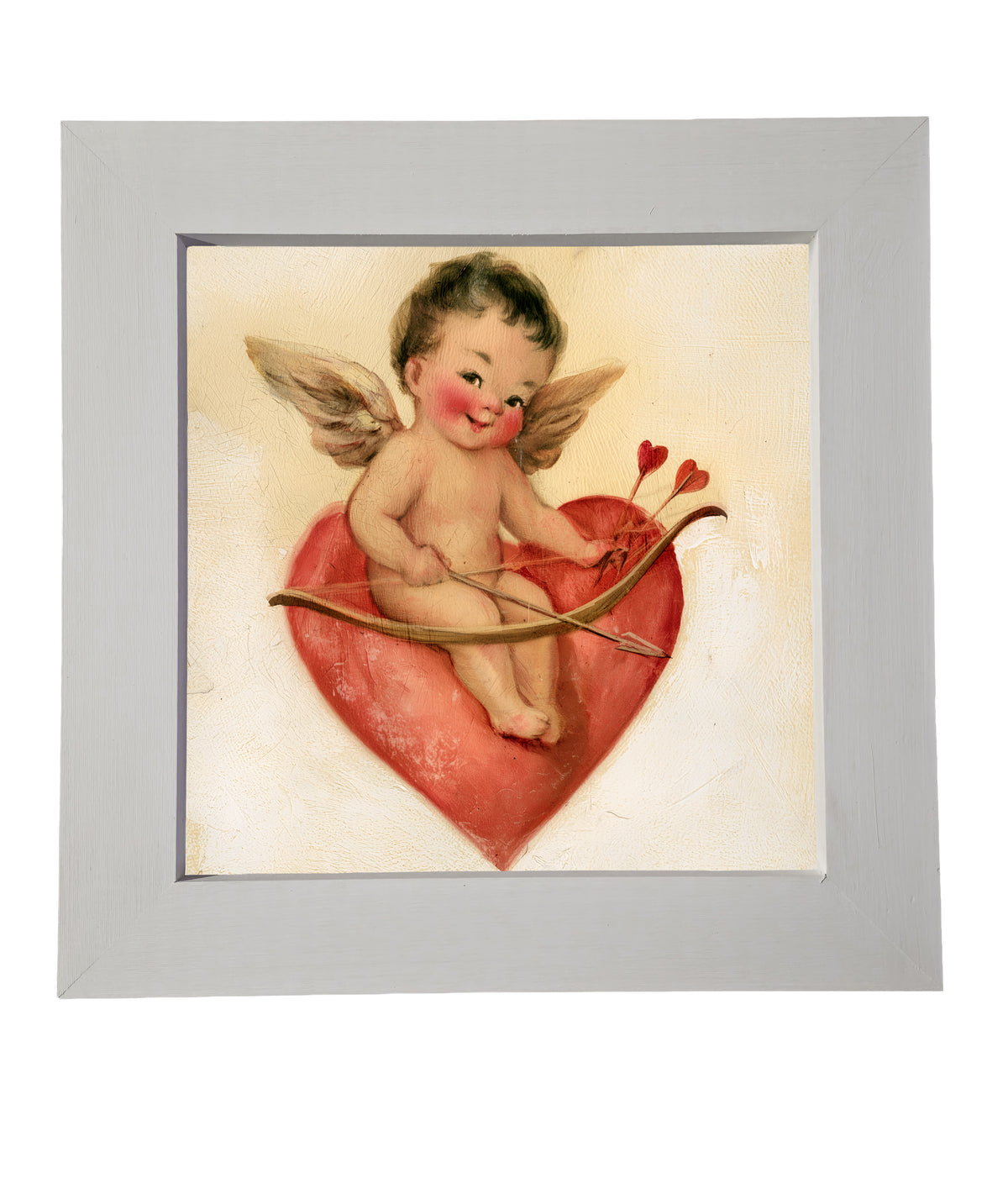 vintage-style framed art of a cheerful Cupid sitting playfully, rustic farmhouse frame